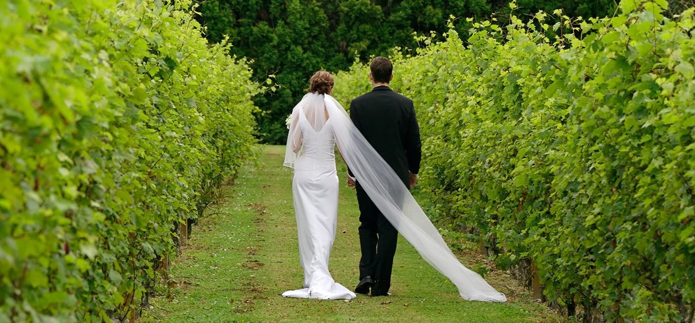bride-and-groom-walking-in-vineyard-wide