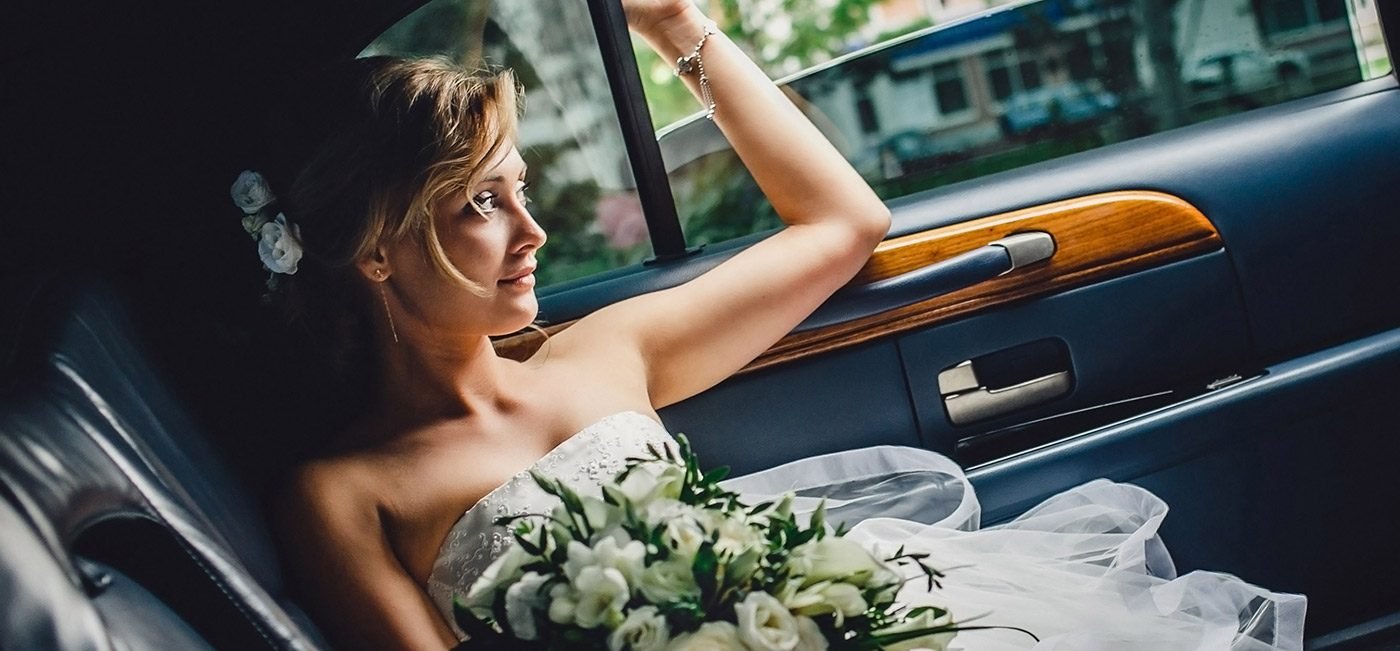 wedding-bride-riding-in-private-chauffeur-wide